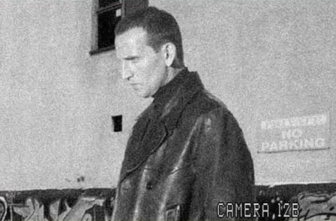 A black and white screengrab captured on a security camera of Doctor Who, at the bottom right it says 'Camera 12B'