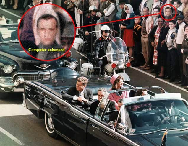Color photograph of President John F. Kennedy's motorcade traveling through a crowded city street, with spectators lining both sides of the road. Kennedy and First Lady Jacqueline Kennedy are seated in the open-top presidential limousine, accompanied by other occupants, while police officers on motorcycles escort the procession. A man standing among the crowd on the right side of the street is highlighted with a red circle, and a larger computer-enhanced inset shows a close-up of his face. In this image, the circled man is identified as the Doctor.